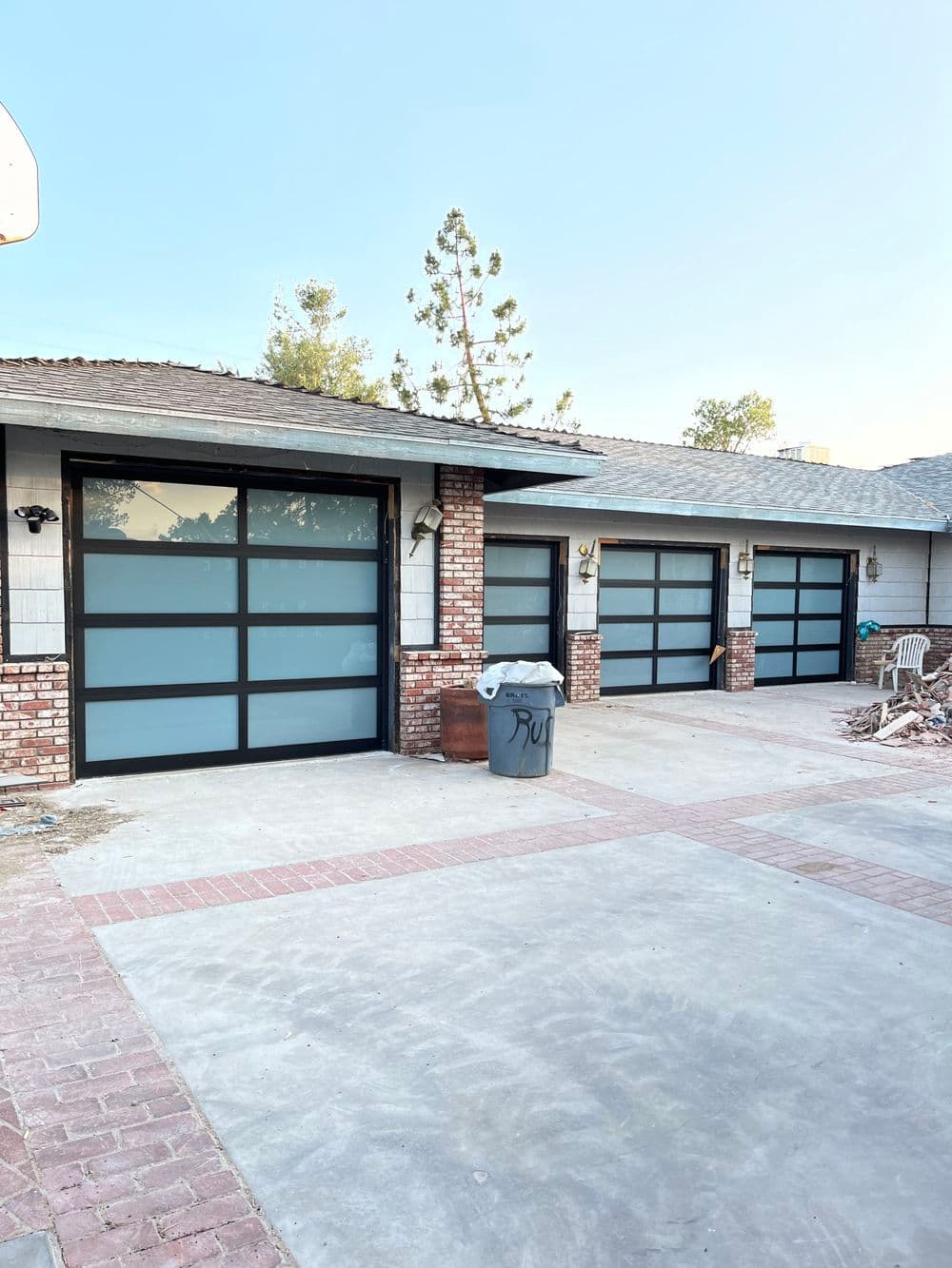 Modern garage doors with frosted glass panels on a residential home exterior.